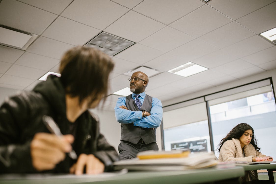 Quality assurance professional reviewing assessment documents for moderation